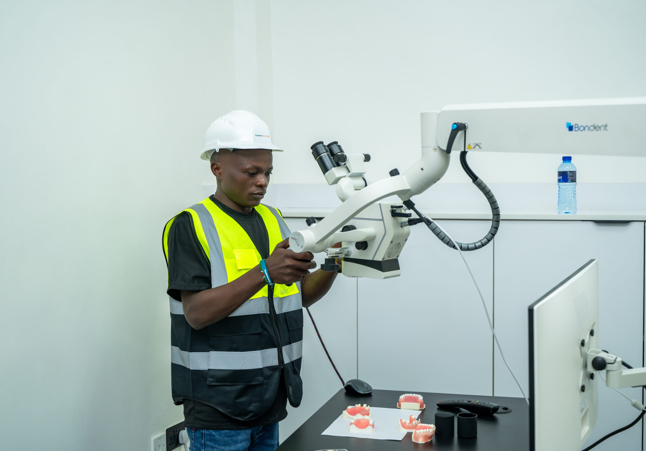 Dental engineer installing high-precision dental microscope in East Africa